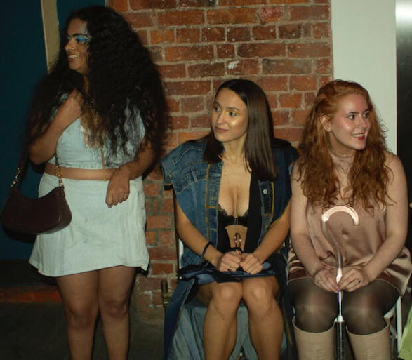 Three models with disabilities waiting to walk the runway in Recondition looks.